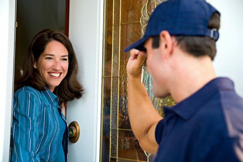 Employee greeting customer at the door